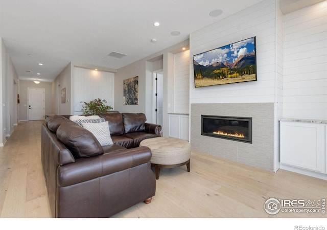 3351 Heron Lakes Pkwy, Berthoud, CO 80513 - living room featuring visible vents, a glass covered fireplace, light wood finished floors, and recessed lighting