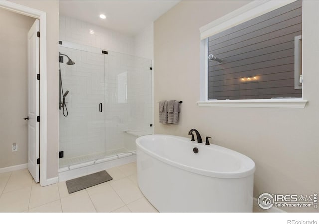 3351 Heron Lakes Pkwy, Berthoud, CO 80513 - full bathroom featuring recessed lighting, a shower stall, a freestanding tub, and tile patterned flooring