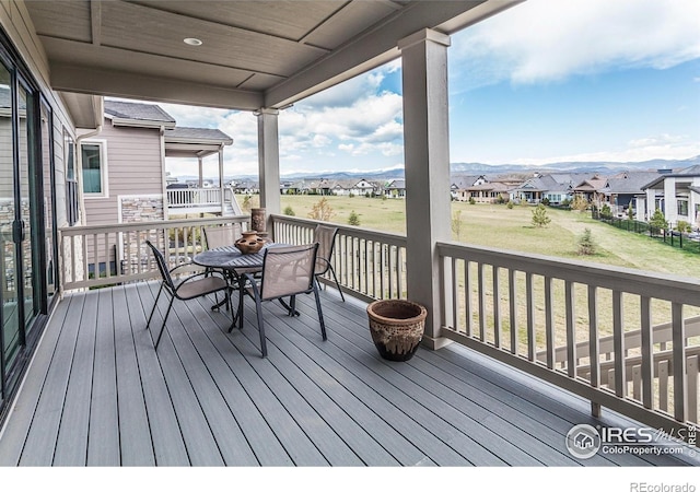 3351 Heron Lakes Pkwy, Berthoud, CO 80513 - deck with a residential view, a lawn, and outdoor dining area