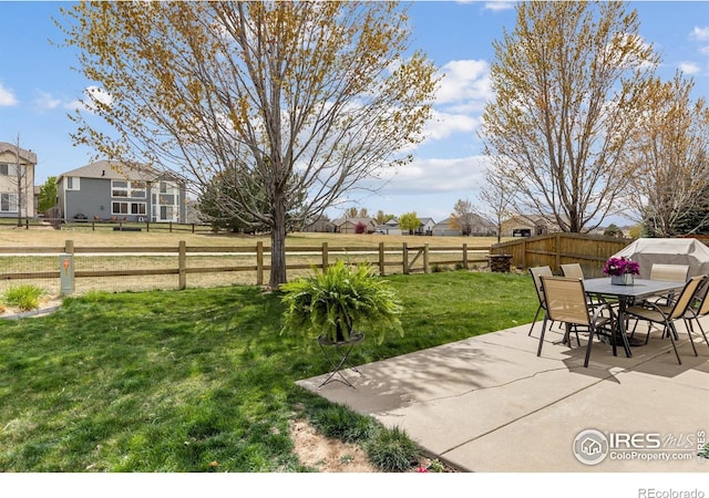 view of patio with a fenced backyard and outdoor dining area