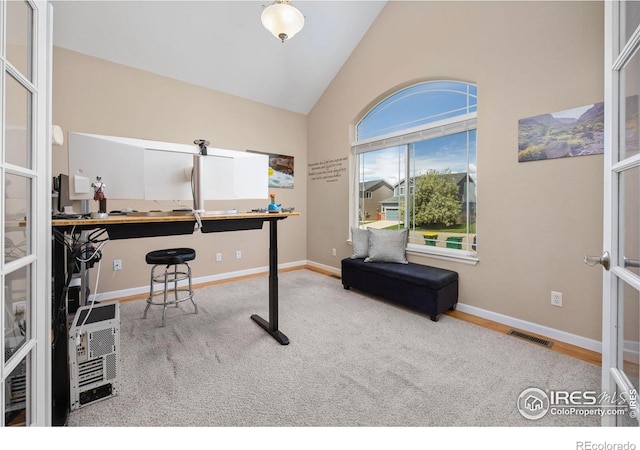 home office with visible vents, baseboards, and high vaulted ceiling