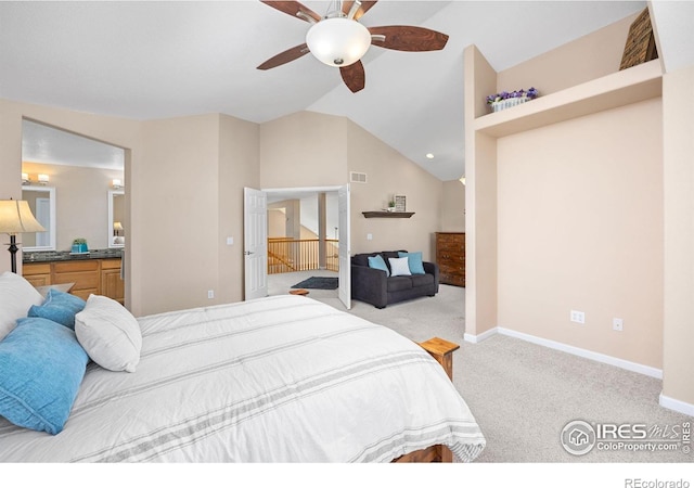 bedroom featuring connected bathroom, visible vents, light colored carpet, baseboards, and lofted ceiling