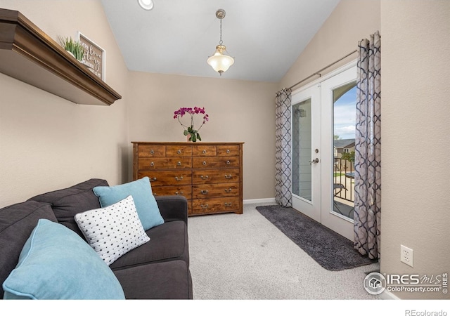 interior space with vaulted ceiling, baseboards, carpet, and french doors