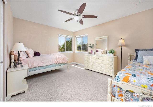 bedroom featuring a ceiling fan, baseboards, and carpet