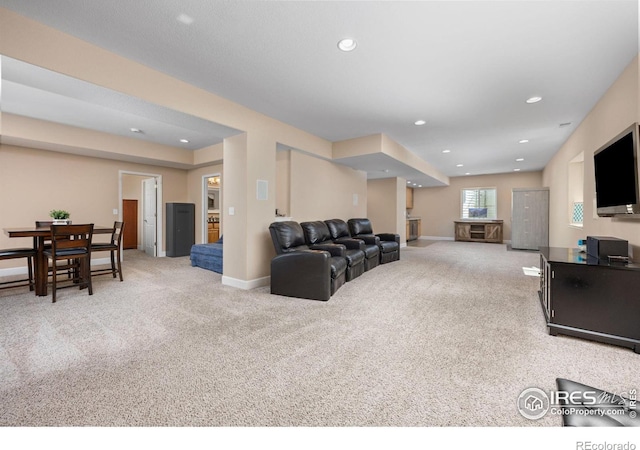 living room with carpet floors, recessed lighting, and baseboards