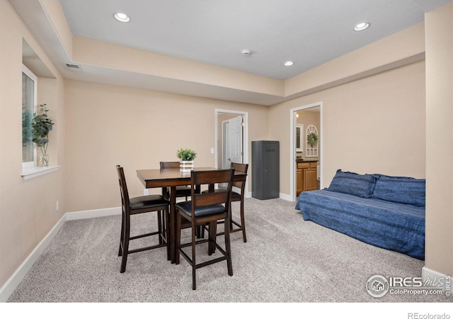 dining area featuring light colored carpet, recessed lighting, and baseboards