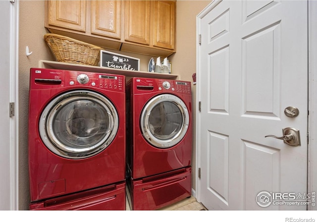 washroom with cabinet space and washer and dryer