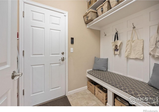 mudroom with baseboards and light tile patterned floors
