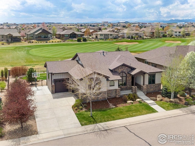 drone / aerial view with a residential view and golf course view