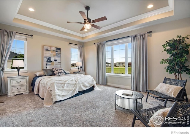 carpeted bedroom featuring a ceiling fan, a raised ceiling, baseboards, ornamental molding, and recessed lighting