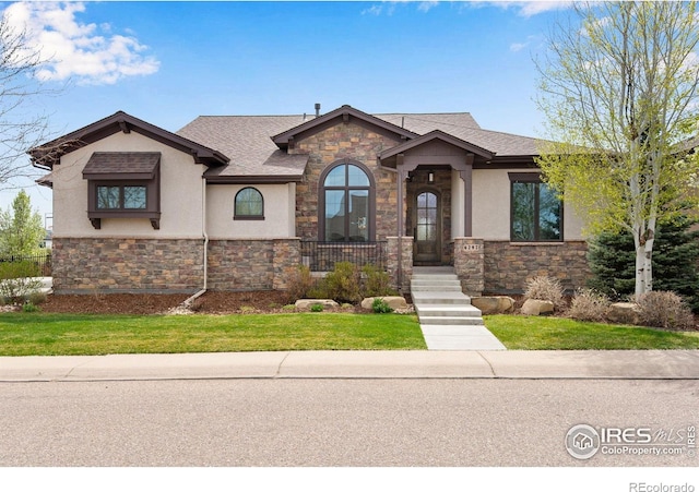 6297 Crooked Stick Dr, Windsor, CO 80550 - view of front facade with stone siding, stucco siding, and a front lawn