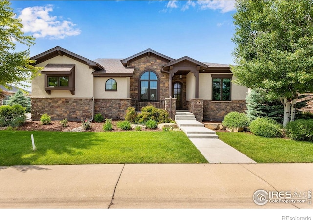 6297 Crooked Stick Dr, Windsor, CO 80550 - view of front of property featuring stone siding, stucco siding, and a front yard