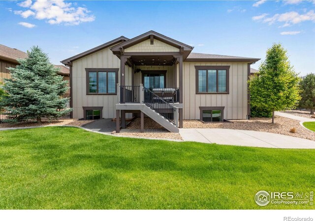 6297 Crooked Stick Dr, Windsor, CO 80550 - view of front of house with a front yard and board and batten siding