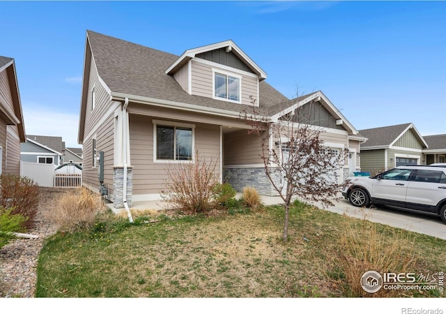 1030 Grand Ave, Windsor, CO 80550 - craftsman-style house with concrete driveway, a front lawn, roof with shingles, and a garage