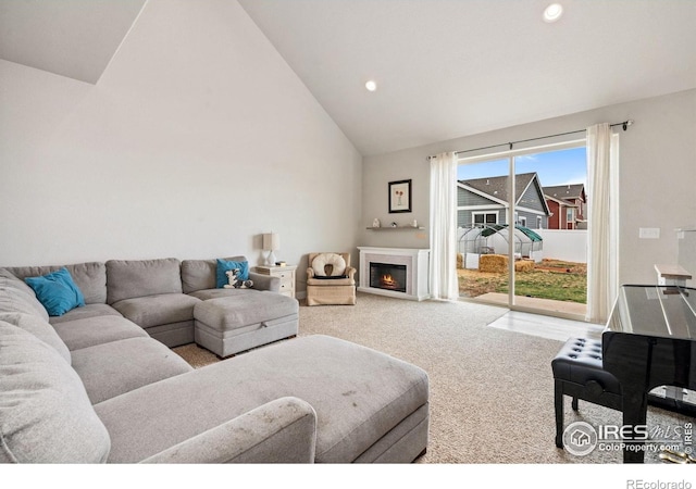 1030 Grand Ave, Windsor, CO 80550 - carpeted living area featuring recessed lighting, a warm lit fireplace, and high vaulted ceiling