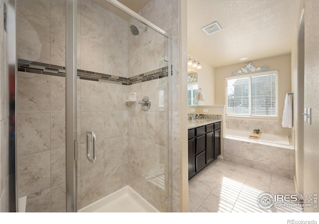 2433 Tabor St, Berthoud, CO 80513 - full bath featuring a bath, a shower stall, vanity, tile patterned flooring, and a textured ceiling