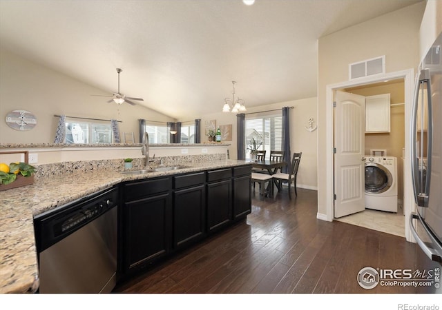 2433 Tabor St, Berthoud, CO 80513 - kitchen featuring washer / clothes dryer, stainless steel appliances, a sink, lofted ceiling, and dark wood-type flooring
