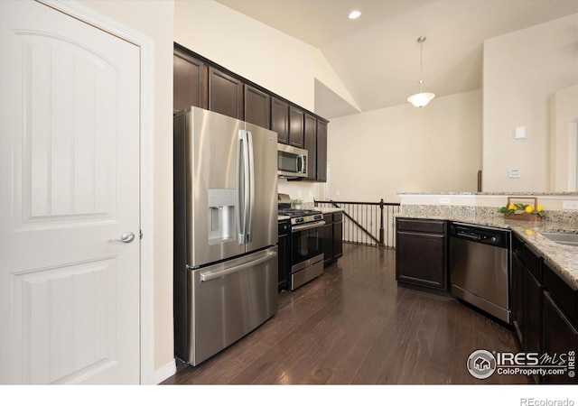 2433 Tabor St, Berthoud, CO 80513 - kitchen featuring stainless steel appliances, lofted ceiling, dark wood-style flooring, dark brown cabinetry, and light stone counters