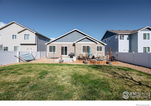 2433 Tabor St, Berthoud, CO 80513 - back of house with a patio area and board and batten siding