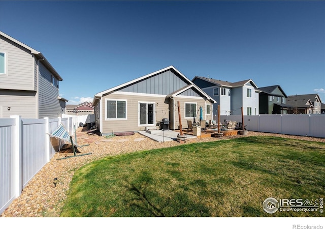 2433 Tabor St, Berthoud, CO 80513 - back of house with board and batten siding, a patio area, and a residential view