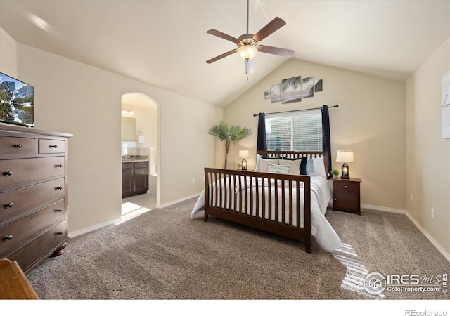 2433 Tabor St, Berthoud, CO 80513 - bedroom featuring light colored carpet, arched walkways, vaulted ceiling, ensuite bathroom, and baseboards