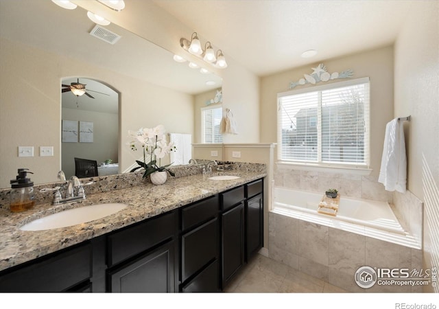 2433 Tabor St, Berthoud, CO 80513 - ensuite bathroom with double vanity, a bath, ceiling fan, and tile patterned flooring