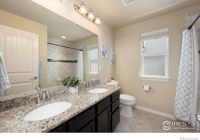 2433 Tabor St, Berthoud, CO 80513 - bathroom featuring double vanity, toilet, baseboards, and marble finish flooring