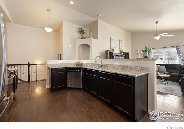 2433 Tabor St, Berthoud, CO 80513 - kitchen with stainless steel appliances, open floor plan, dark wood-style flooring, ceiling fan, and light stone counters