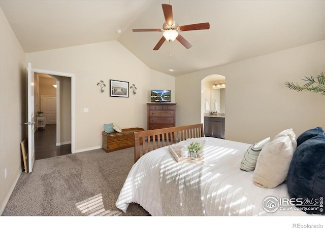 2433 Tabor St, Berthoud, CO 80513 - carpeted bedroom featuring arched walkways, lofted ceiling, baseboards, ensuite bath, and a ceiling fan