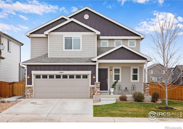 1484 Moraine Valley Dr, Severance, CO 80550 - craftsman-style home with concrete driveway, a front yard, fence, and stone siding