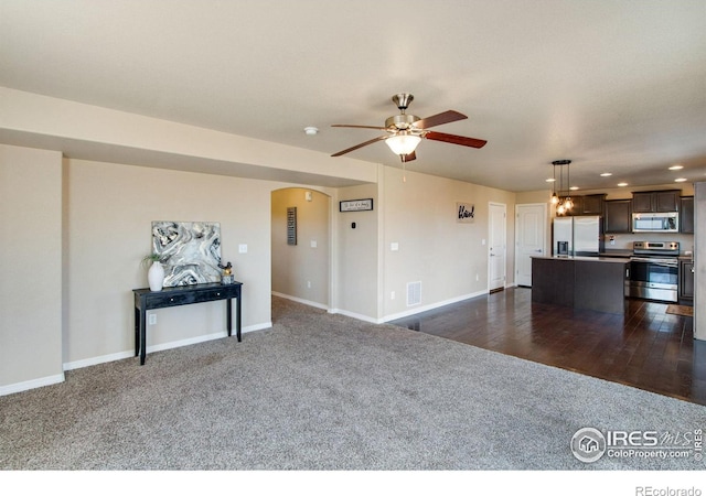1484 Moraine Valley Dr, Severance, CO 80550 - living room with visible vents, dark colored carpet, ceiling fan, recessed lighting, and arched walkways