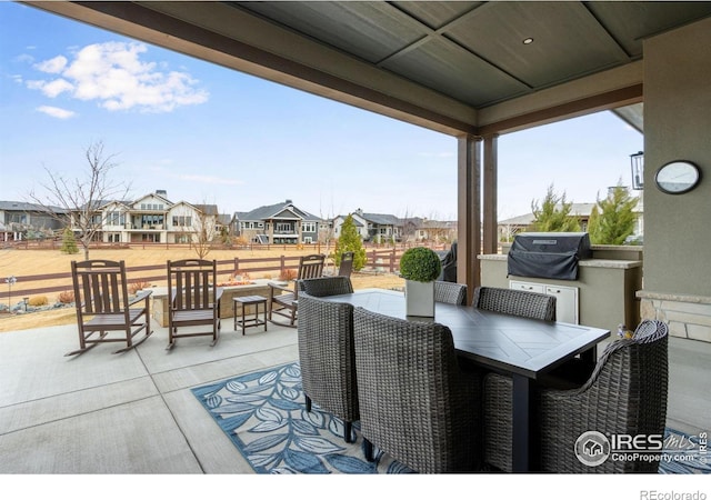 view of patio / terrace with a residential view, area for grilling, outdoor dining area, and fence