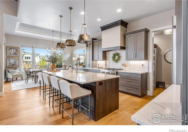 kitchen with gray cabinets, a wealth of natural light, and a sink