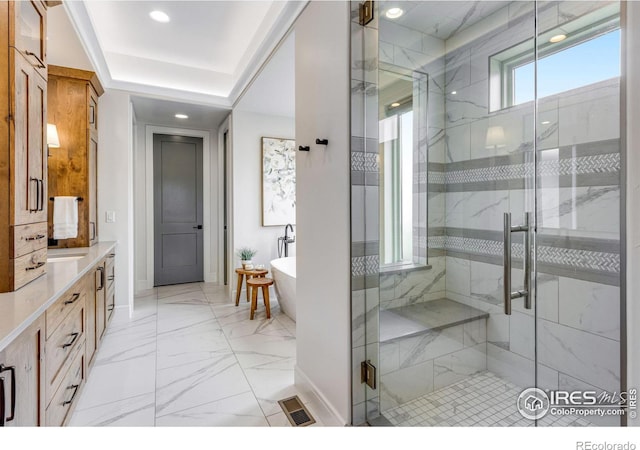 bathroom with baseboards, visible vents, marble finish floor, and a freestanding bath