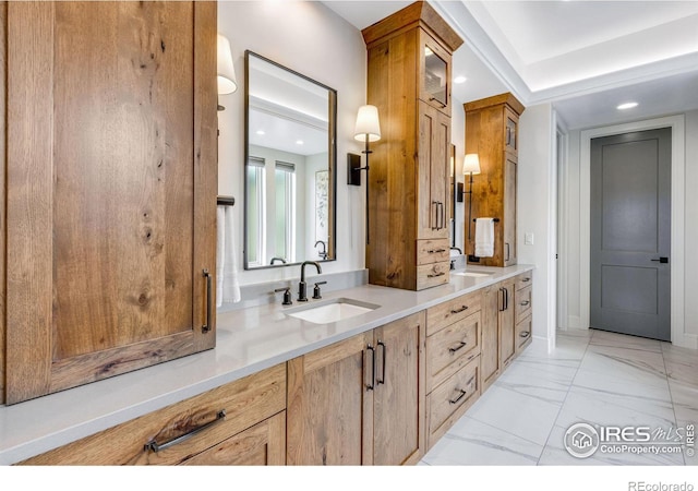bathroom featuring recessed lighting, double vanity, and a sink