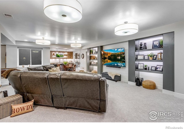 living area with carpet floors and visible vents