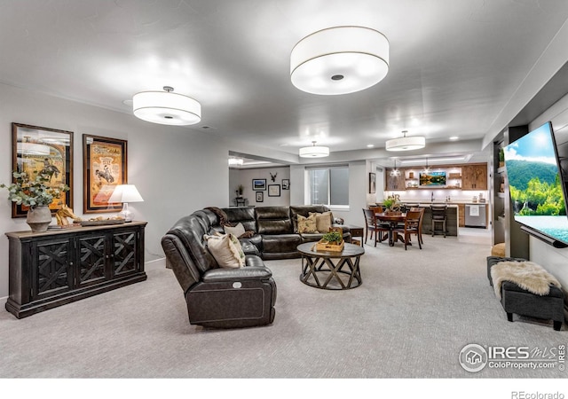 carpeted living room featuring bar area