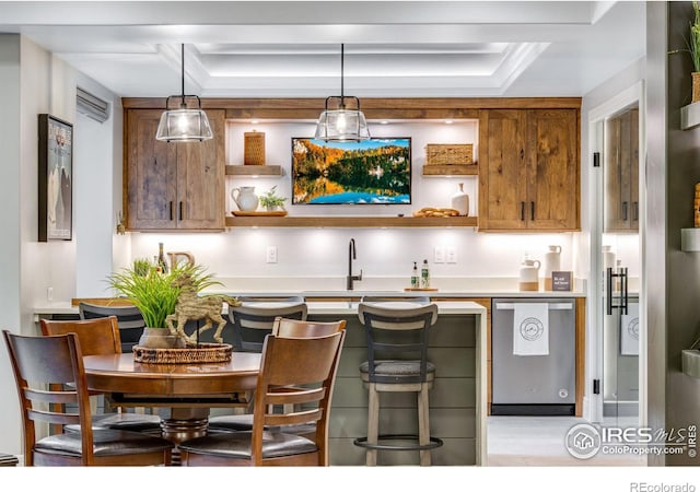 bar with decorative light fixtures, a raised ceiling, dishwasher, and a sink