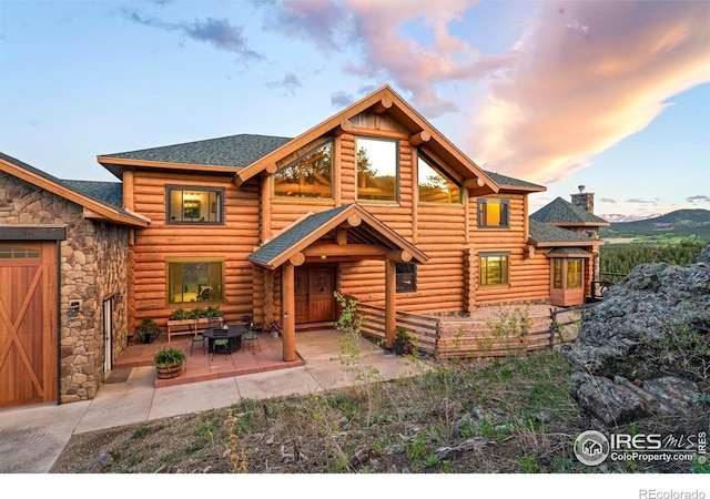 4 Dill Pickle Pl, Black Hawk, CO 80422 - back of house with log siding, a chimney, roof with shingles, and stone siding