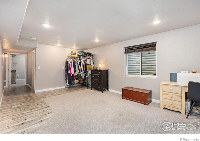 bedroom featuring wood finished floors, baseboards, recessed lighting, and a closet