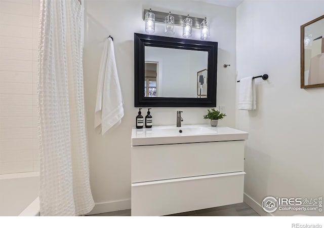 bathroom featuring baseboards and vanity