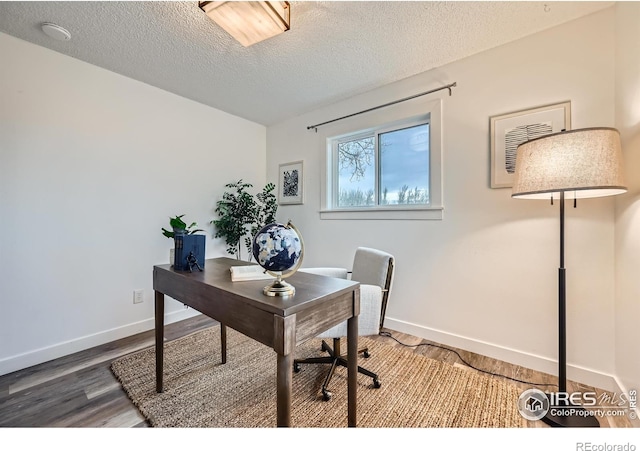 home office with baseboards, wood finished floors, and a textured ceiling