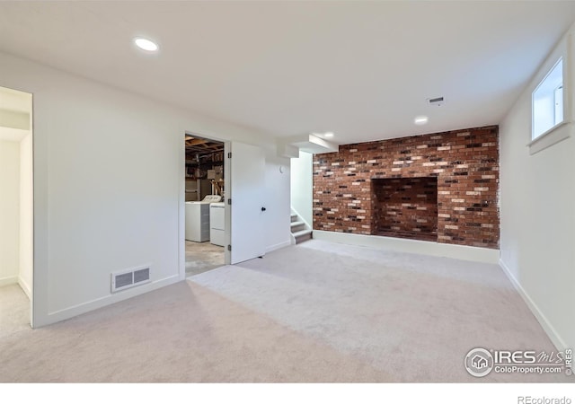 basement with washing machine and dryer, visible vents, carpet, and stairway