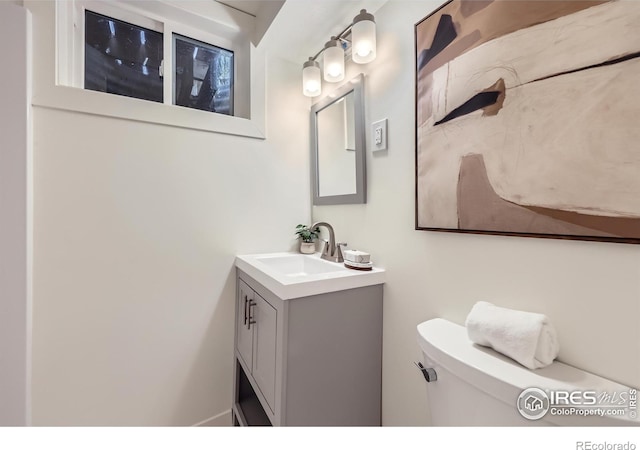 bathroom featuring toilet and vanity