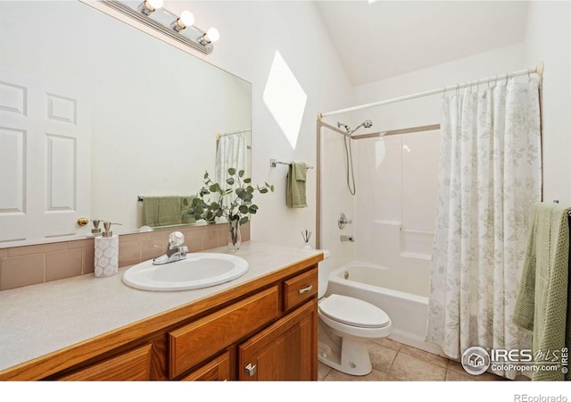 bathroom featuring tile patterned floors, toilet, vaulted ceiling, shower / bathtub combination with curtain, and vanity