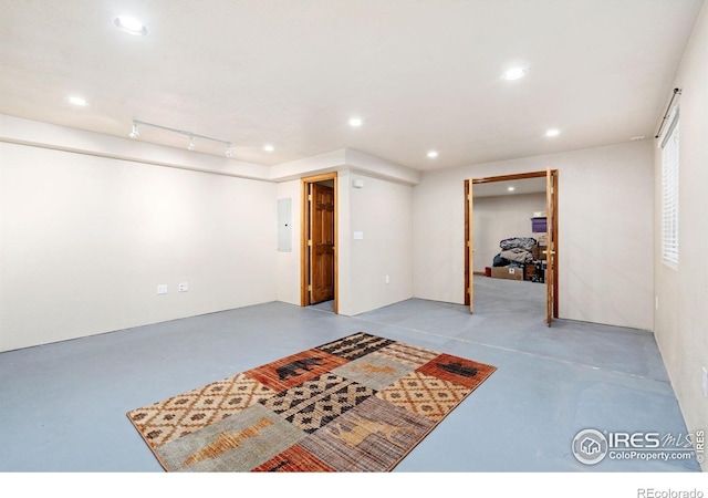 finished below grade area with electric panel and recessed lighting