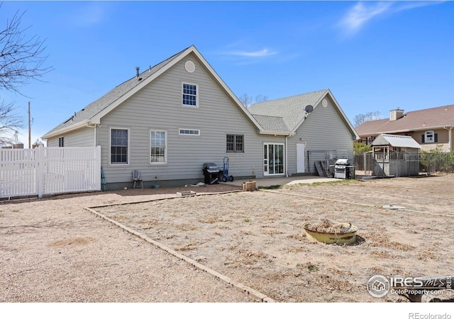back of house featuring fence and a patio area