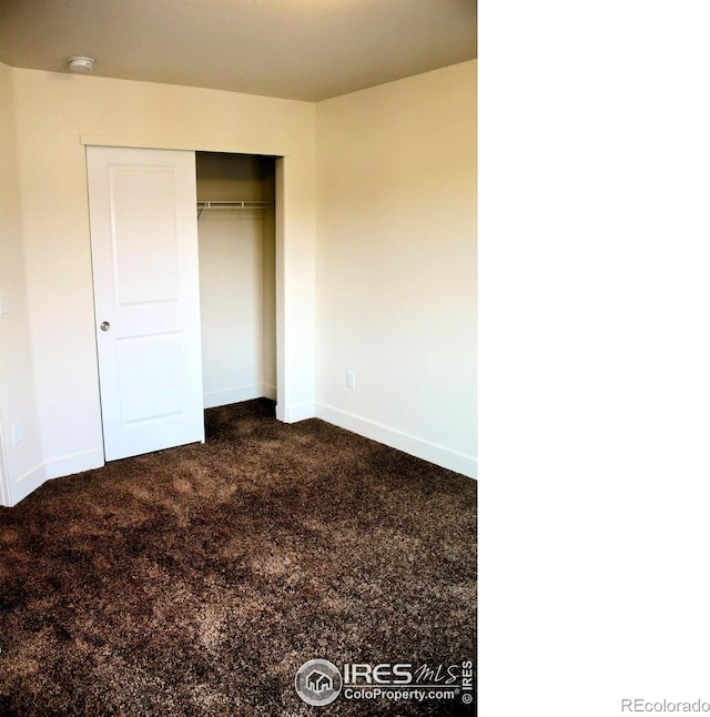 8710 8th St, Greeley, CO 80634 - unfurnished bedroom with dark colored carpet and a closet