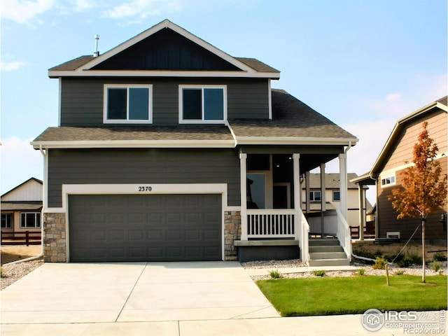 8710 8th St, Greeley, CO 80634 - craftsman-style home with a porch, stone siding, an attached garage, and driveway