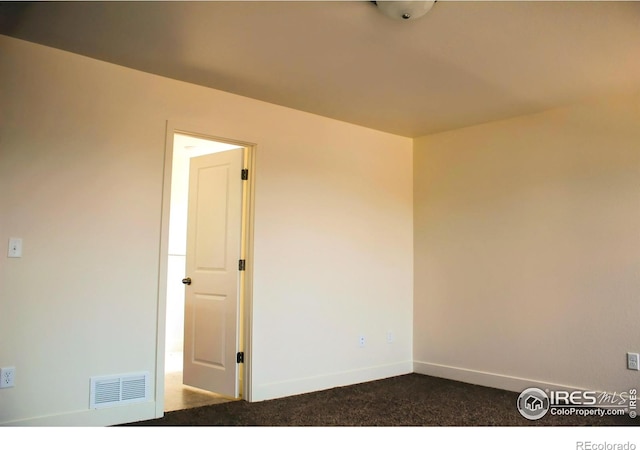 8710 8th St, Greeley, CO 80634 - empty room with dark colored carpet and baseboards